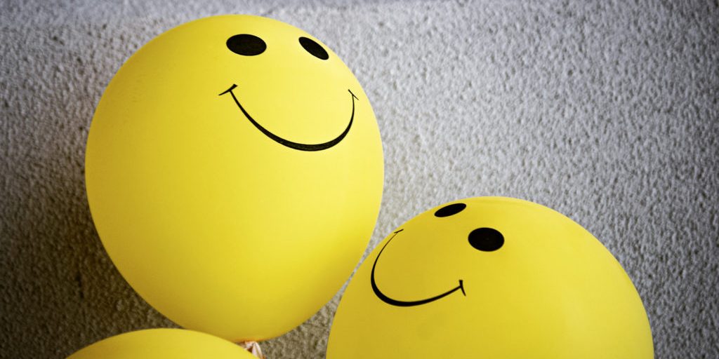 9-Canva-Yellow-Smiley-Emoji-on-Gray-Surface-1024×682